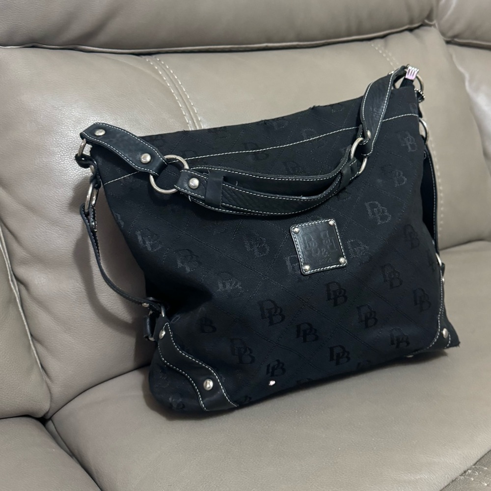 Dooney & Bourke large black fabric and lather signature shoulder bag .